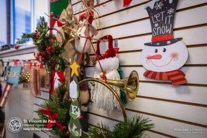 Merry Christmas wall décor with "let it Snow" snowman sign at SVDP Ozaukee County in Port Washington, WI.