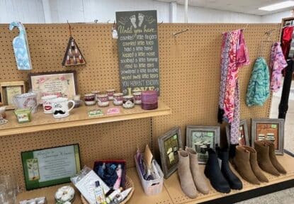 Mother's Day sale display with scarves, shoes, candles, mugs, lotion and more.