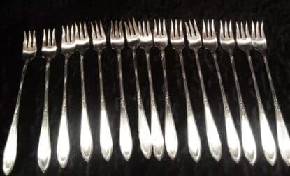 Set of New England silver plate shrimp forks.