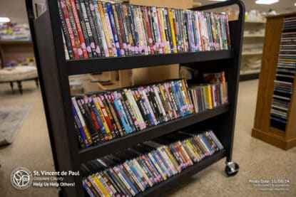 Used DVDs for sale on a mobile rack at St. Vincent de Paul in Port Washington, WI.